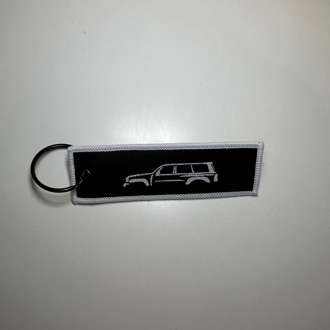 Al Ostoura Black Key Chain (White Border)